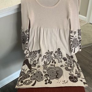 Empire cut, rounded low neckline with sweater ribbed knit on top.